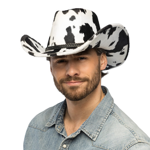 Cowboyhoed Cowchella met koeienvlekken op bol en rand, gedragen bij een spijkerblouse voor een westernfeest