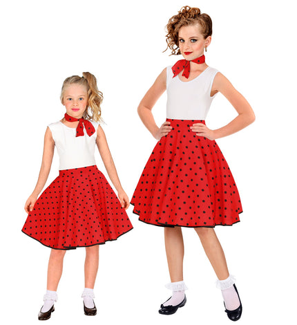 Jaren 50 rok Holly rood met zwarte stippen en halsdoek, gedragen door twee meisjes tijdens een jaren 50-feest