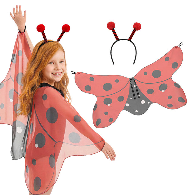 Lieveheersbeestje set Dotty met rood gestippelde vleugels en sprieten met pompons, gedragen door een meisje voor carnaval