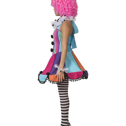 Regenboog clown jurkje Patty van opzij: halterstrik in de nek en zwarte pompons langs de rokzoom