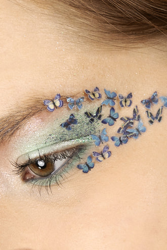 Vlinders in wax blauw als eyedesign, blauwpaarse vlindertjes van ooglid naar slaap met groene glitter